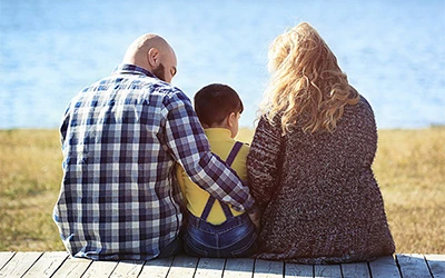 Family sitting on dock