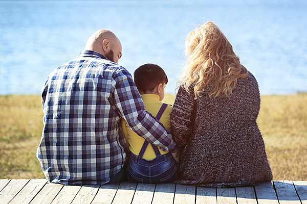 Family sitting on dock