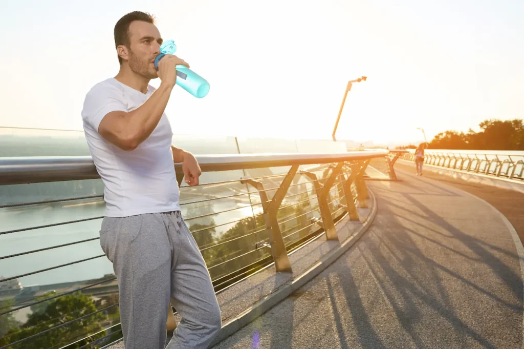 Man drinking water during run