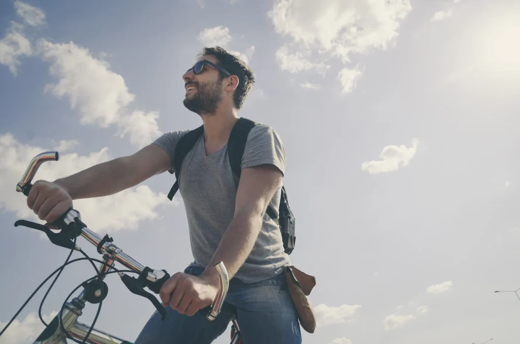 Smiling man on a bike