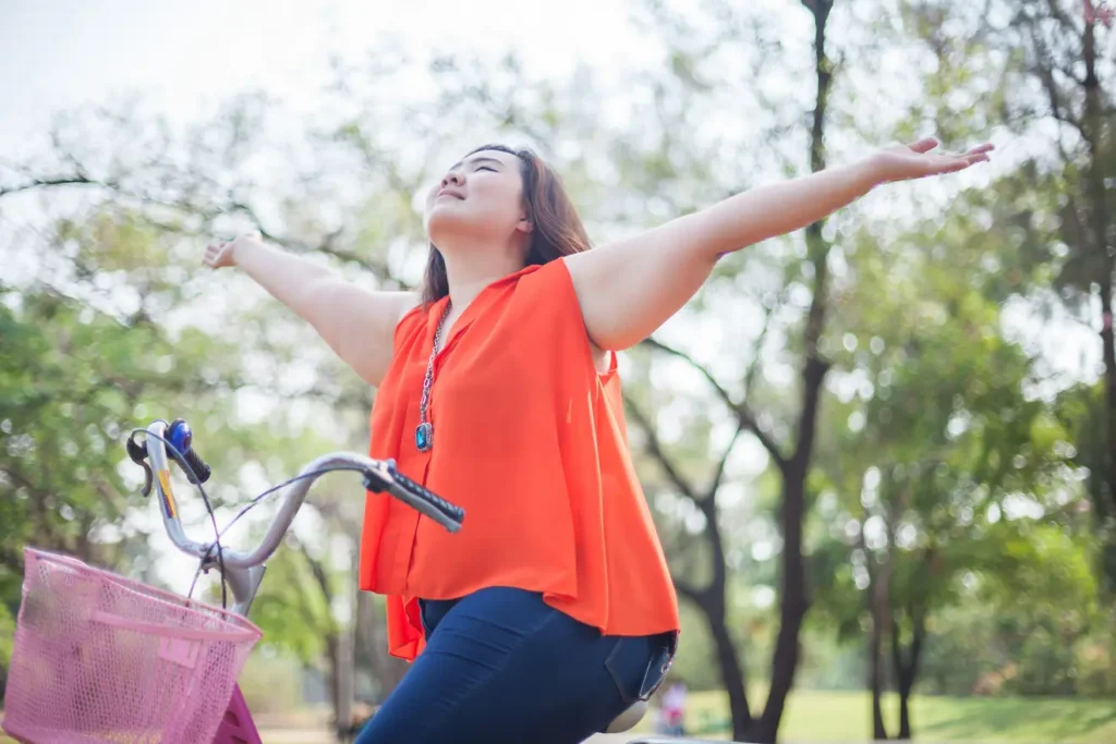 Plus size woman enjoying bike ride