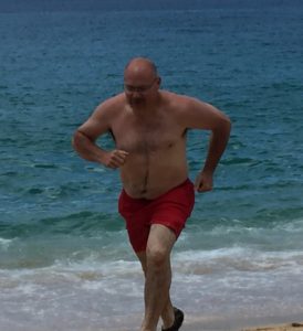 Bariatric patient running on the beach