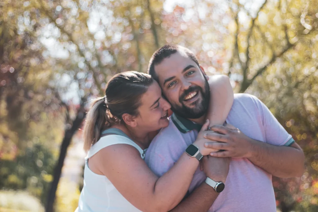 Woman hugging her partner from behind