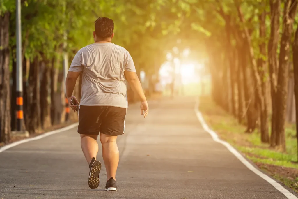 Overweight man on a walk outside