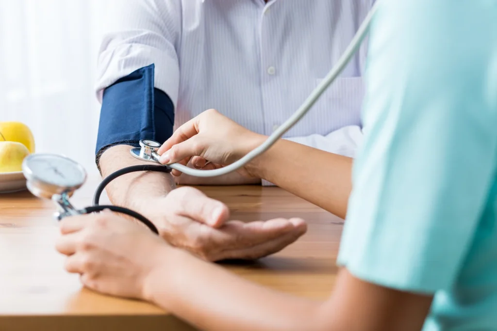 Doctor taking patient's blood pressure